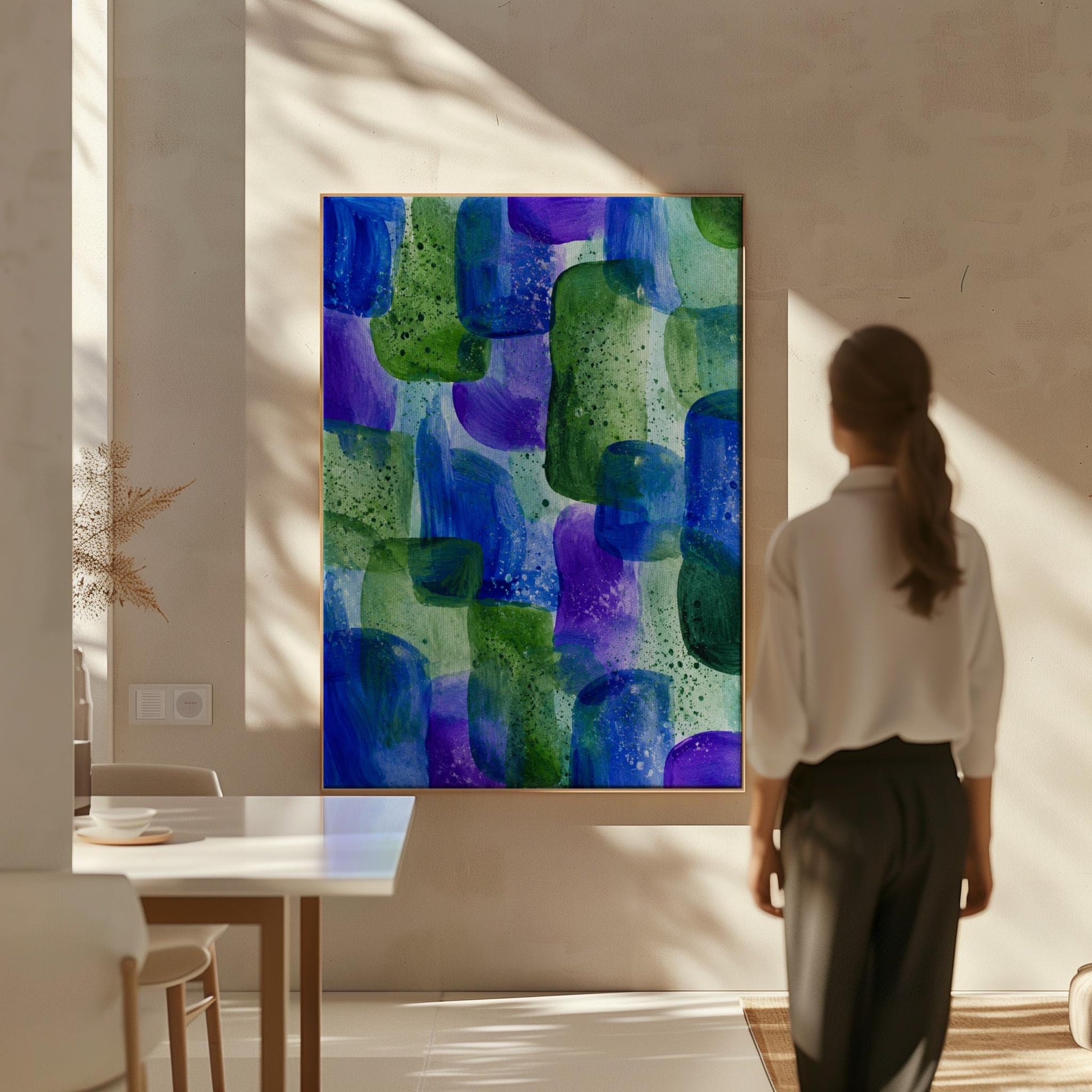 Painterly blocks in saturated blue purple and green, canvas print seen in a warm interior with natural light