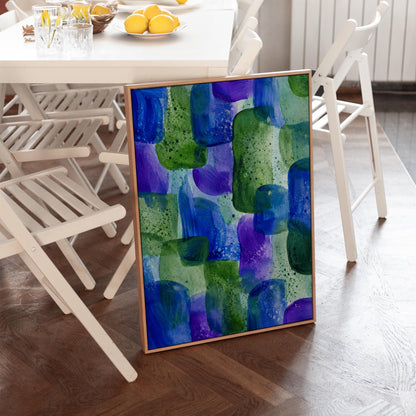 Painterly blocks in saturated blue purple and green, canvas print displayed on a neutral wall in a styled interior