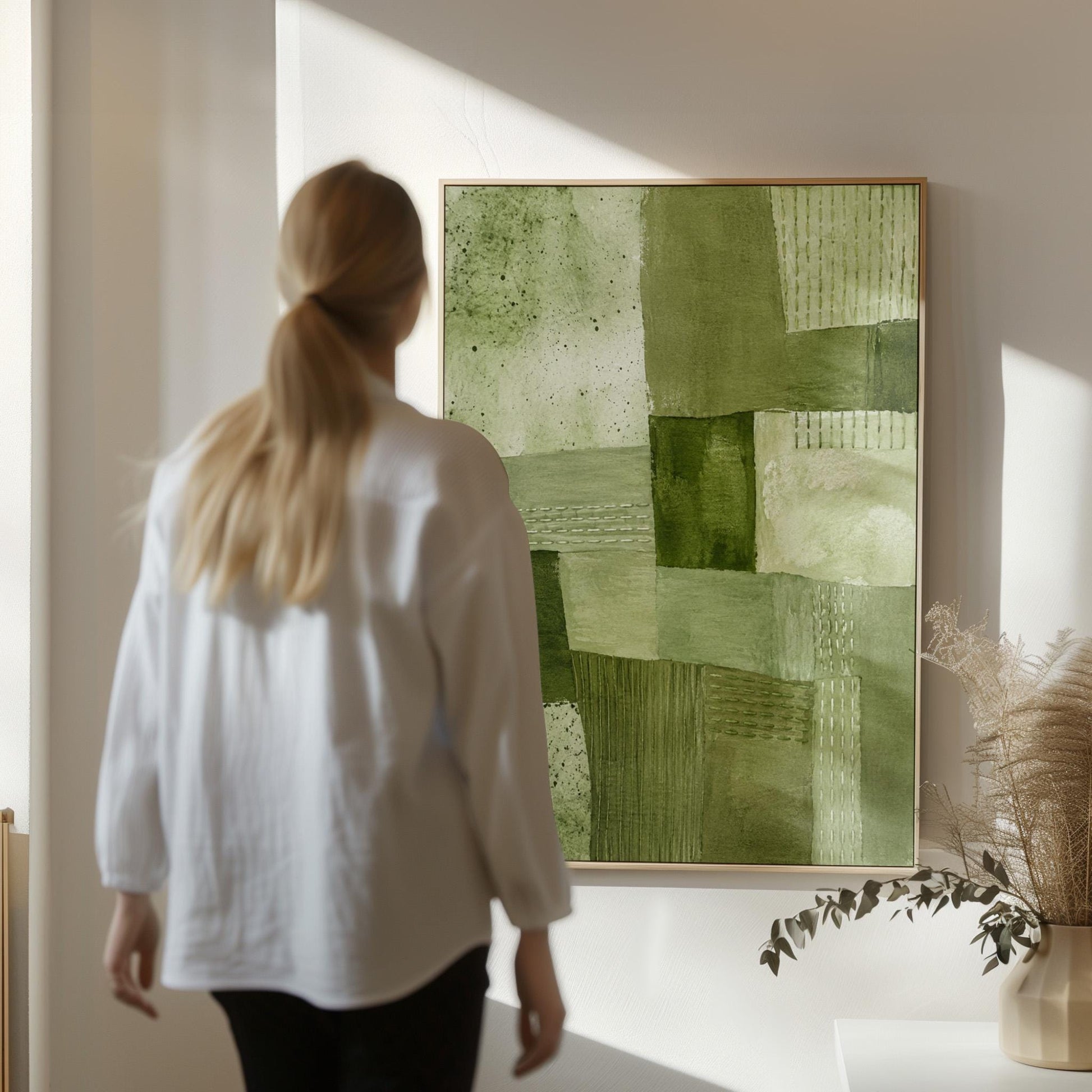 Patchwork of olive and moss green field blocks, canvas print styled against a soft white wall