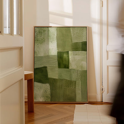 Patchwork of olive and moss green field blocks, canvas print presented in a light, minimal room