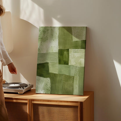 Patchwork of olive and moss green field blocks, canvas wall art seen in a warm interior with natural light