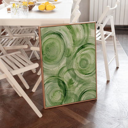Concentric ripple rings in soft watercolor greens, canvas print displayed on a neutral wall in a styled interior