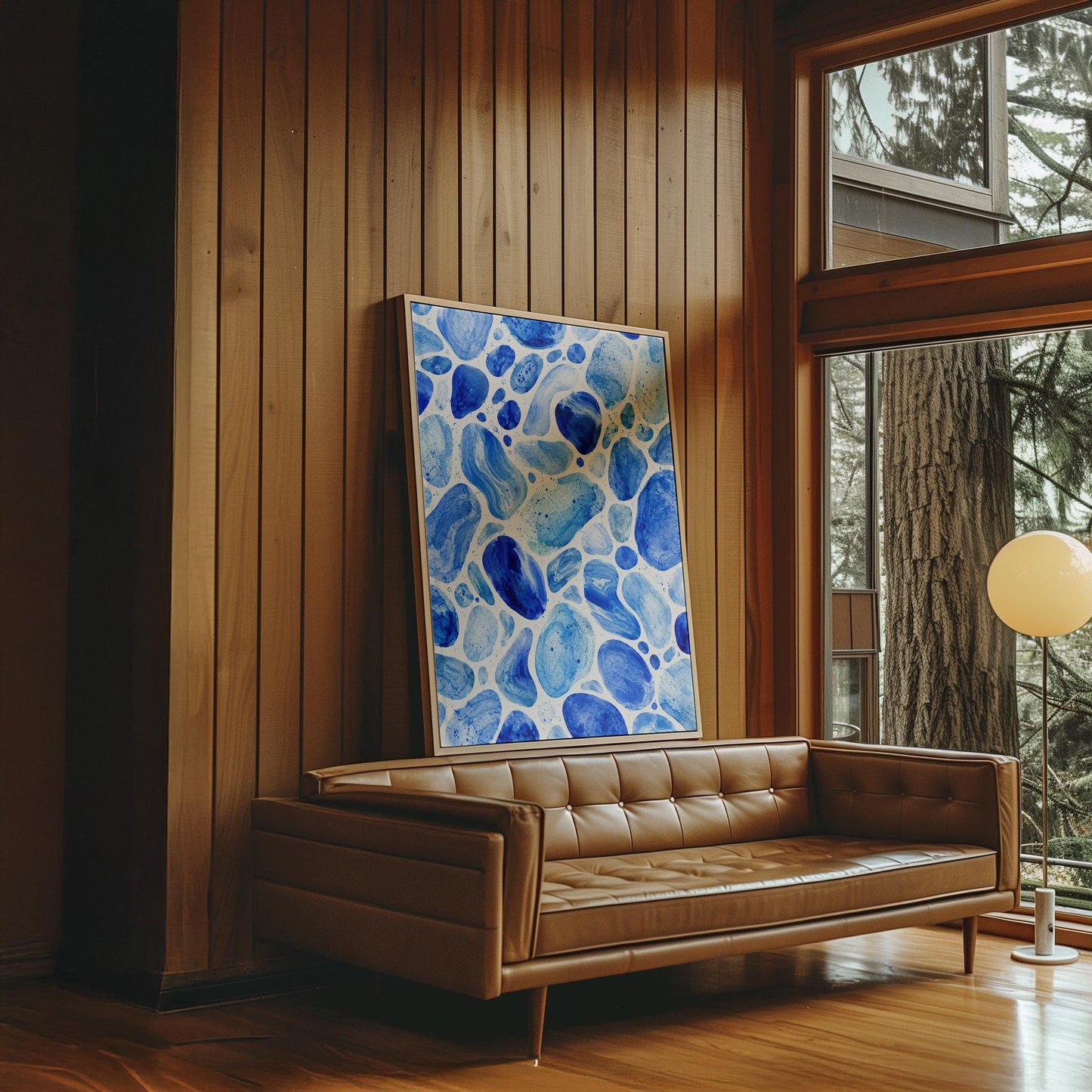 Watercolor pebbles in shades of sky blue and cobalt, canvas print presented in a light, minimal room