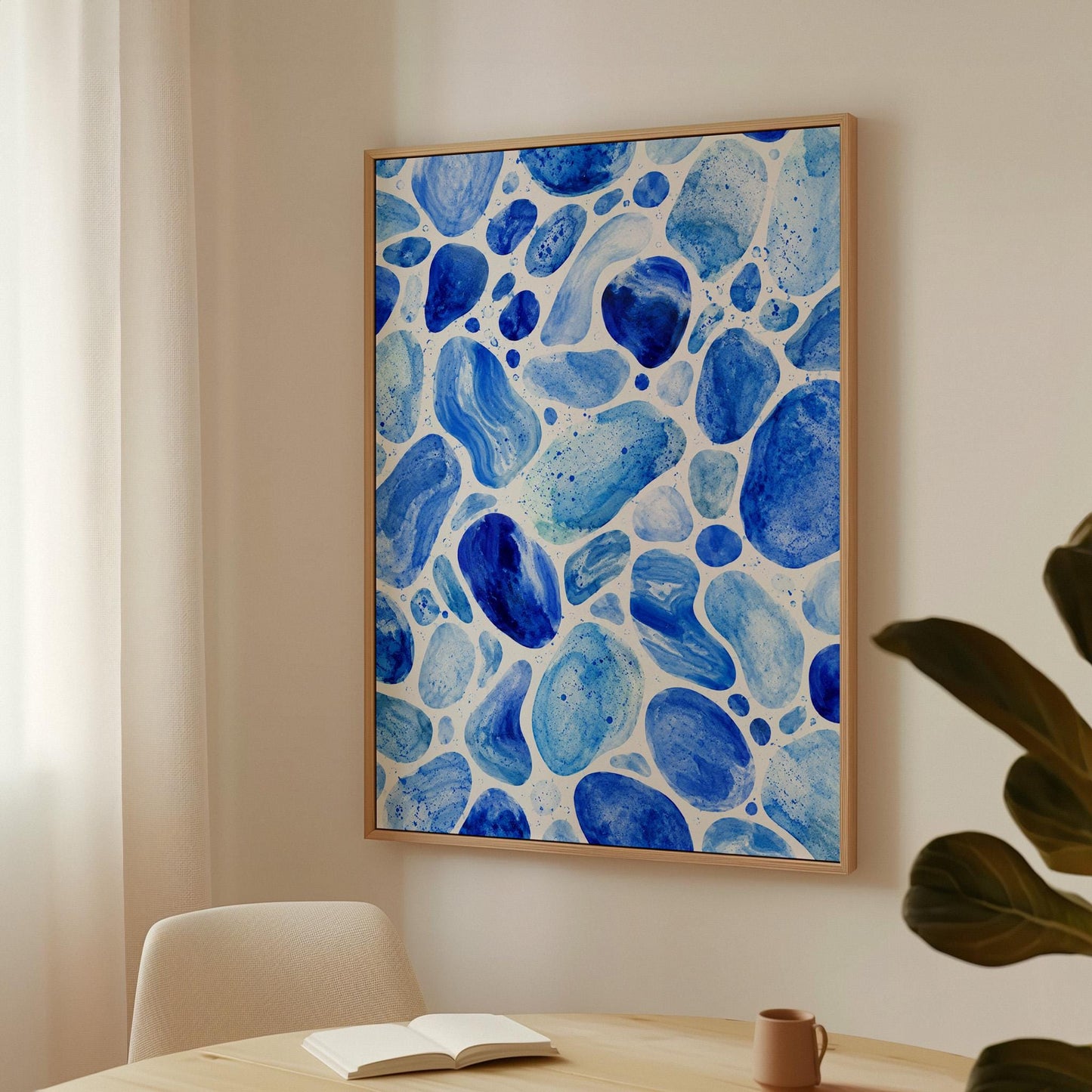 Watercolor pebbles in shades of sky blue and cobalt, canvas print on a quiet wall in a considered interior