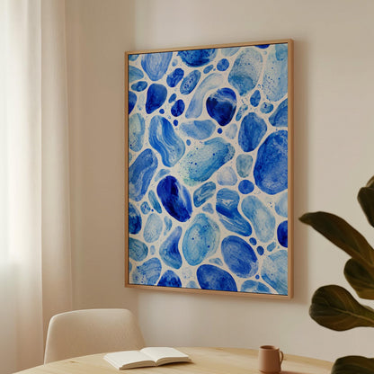 Watercolor pebbles in shades of sky blue and cobalt, canvas print on a quiet wall in a considered interior