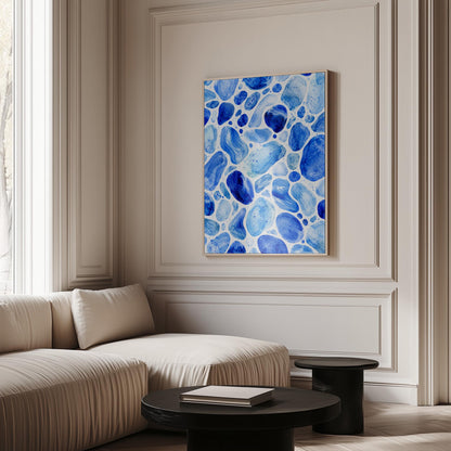 Watercolor pebbles in shades of sky blue and cobalt, canvas wall art seen in a warm interior with natural light