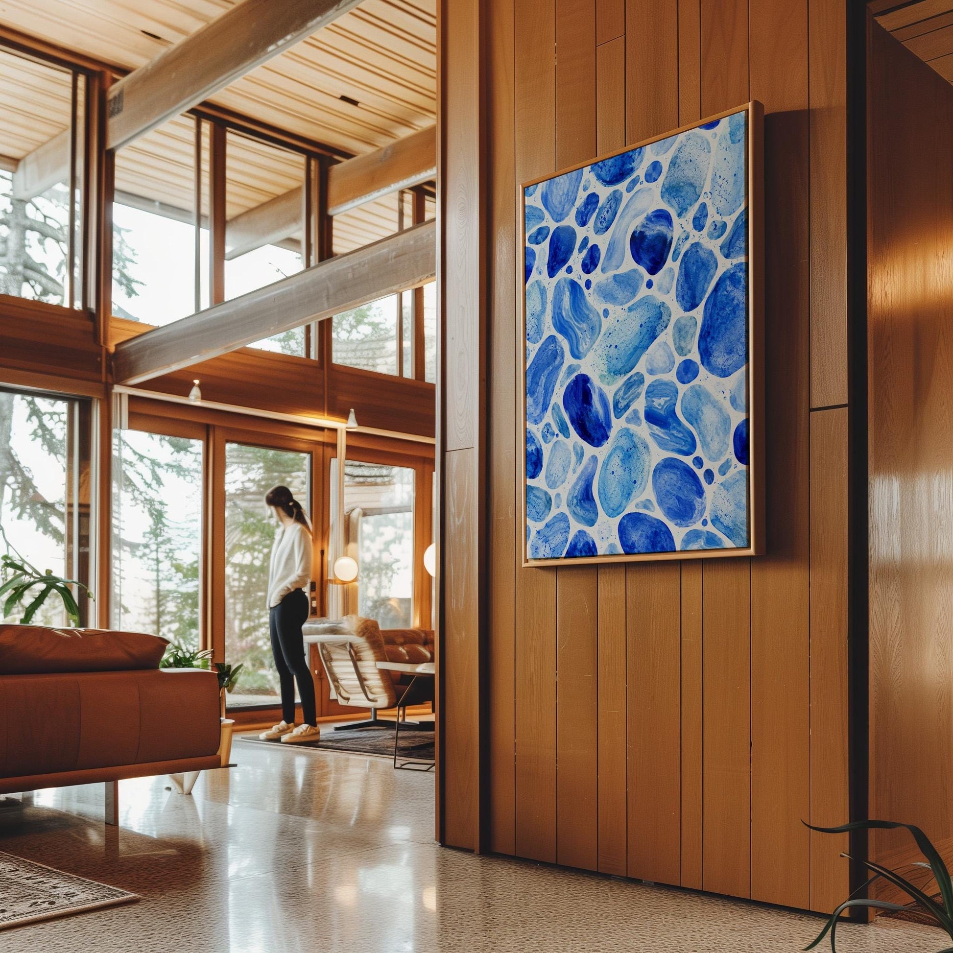Watercolor pebbles in shades of sky blue and cobalt, canvas wall art presented in a light, minimal room
