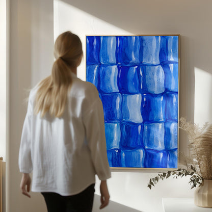Grid of rounded squares in layered cobalt blues, canvas wall art hanging in a calm, modern living space