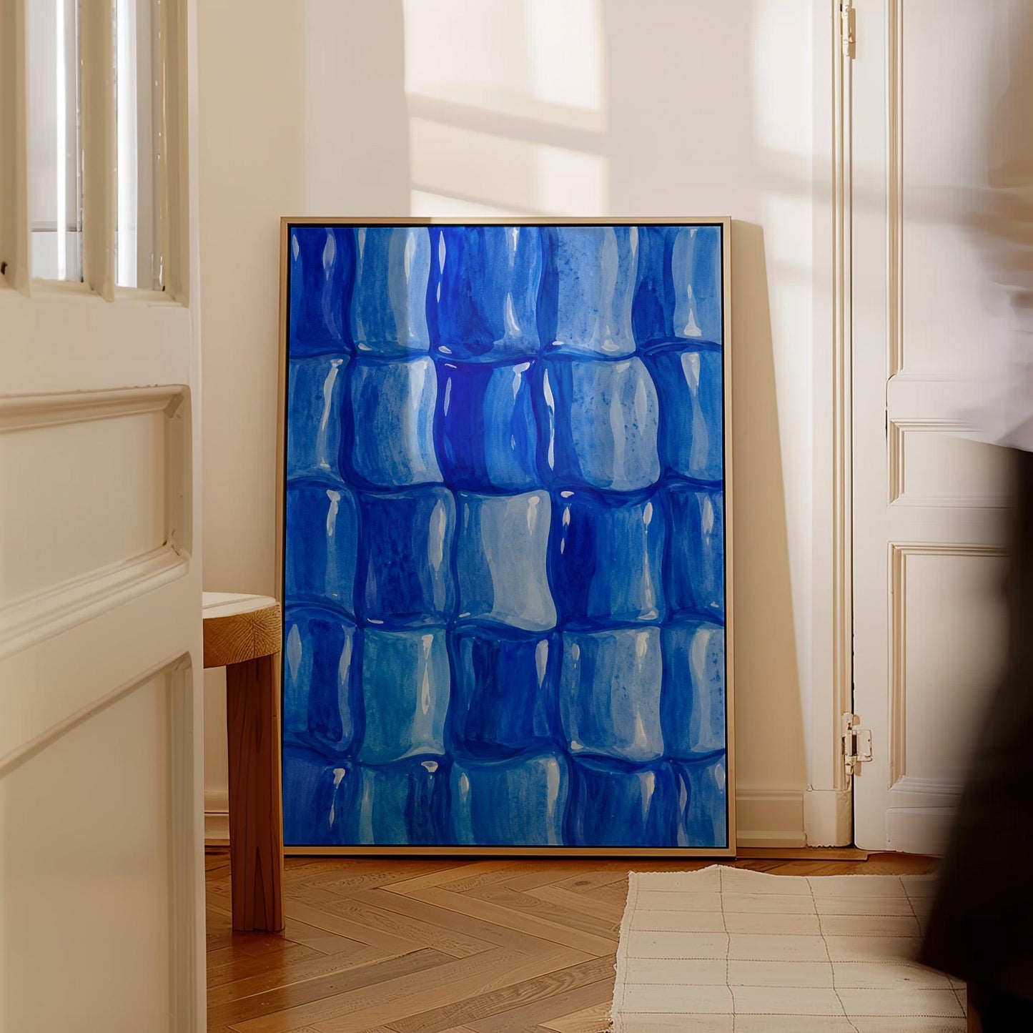 Grid of rounded squares in layered cobalt blues, canvas wall art presented in a light, minimal room
