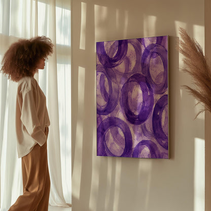Swirling amethyst purple rings on pale background, canvas print displayed on a neutral wall in a styled interior