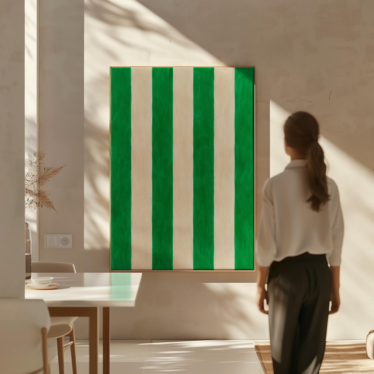 Bold vertical cabana stripes in emerald green and cream, canvas wall art presented in a light, minimal room