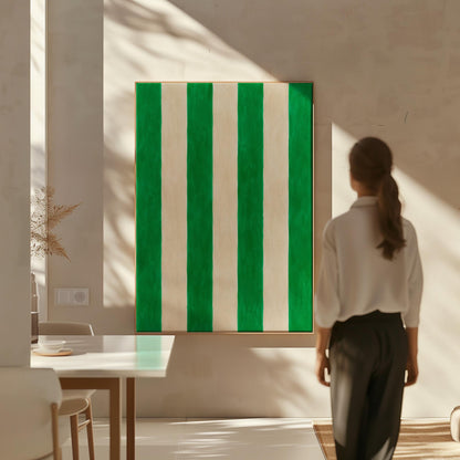 Bold vertical cabana stripes in emerald green and cream, canvas wall art presented in a light, minimal room