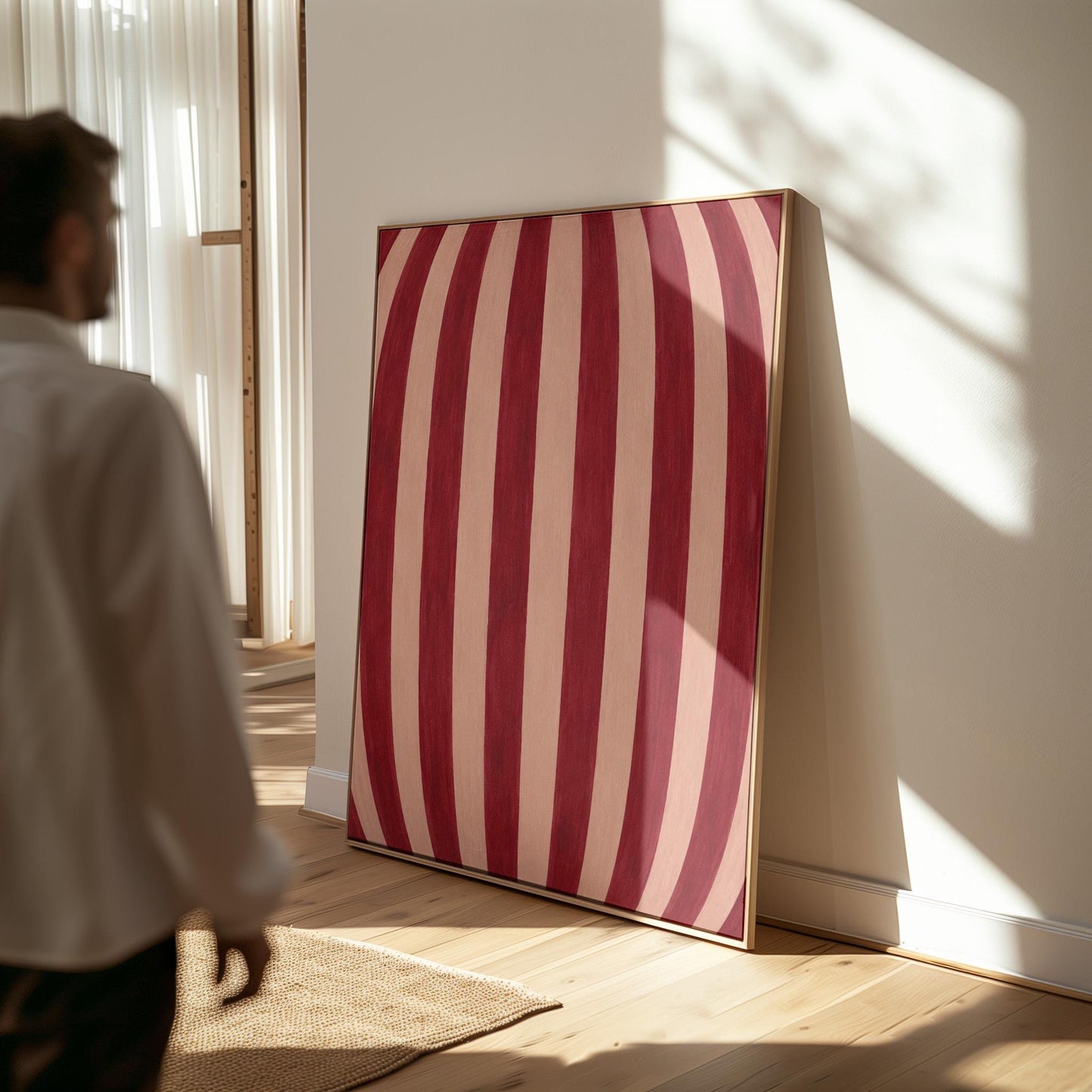 Curved burgundy stripes bowing over blush background, canvas print hanging in a calm, modern living space