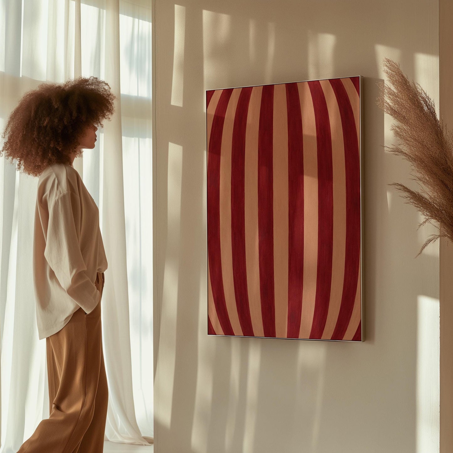 Curved burgundy stripes bowing over blush background, canvas print on a quiet wall in a considered interior