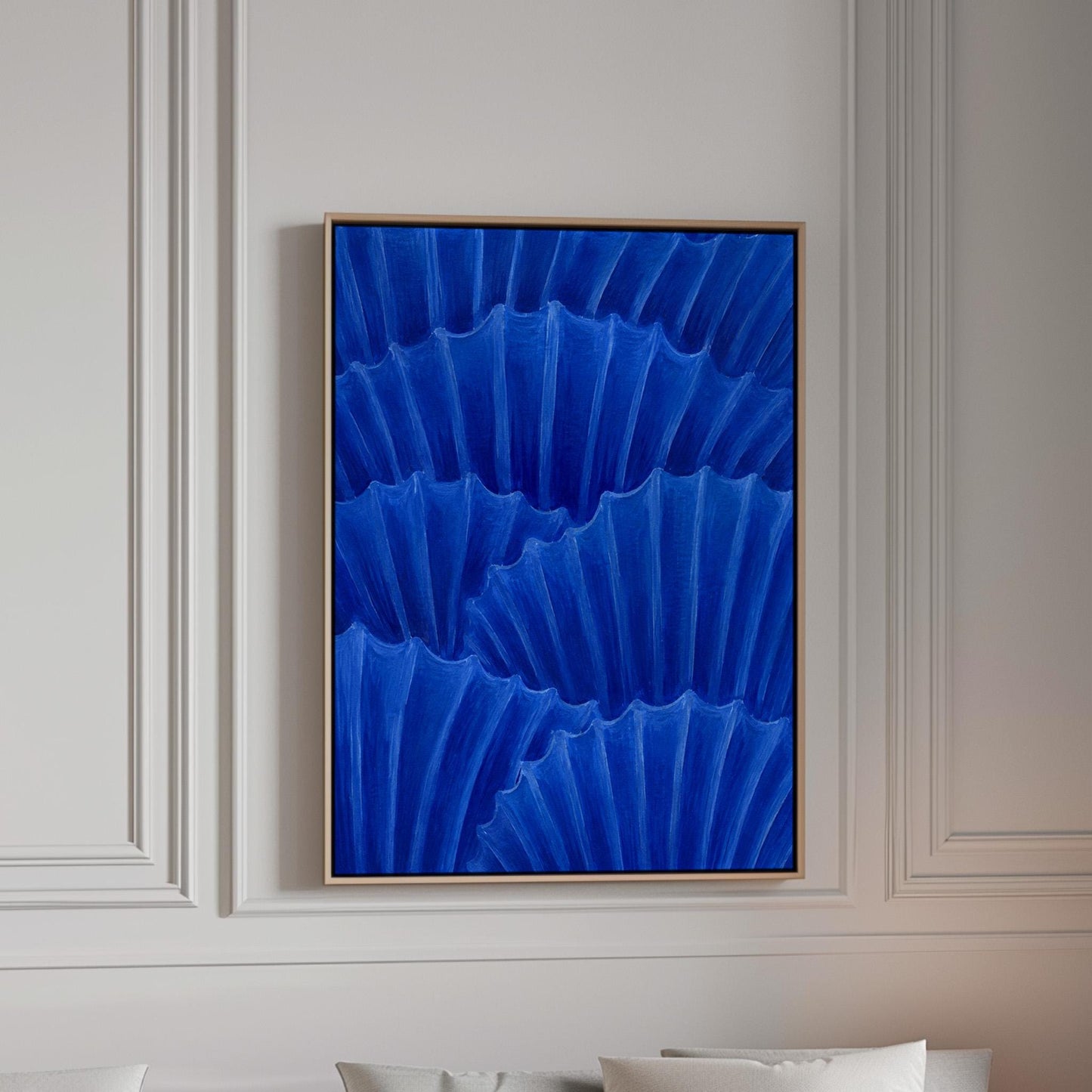 Overlapping pleated fan shapes in deep royal blue, canvas print in a bright room with natural daylight