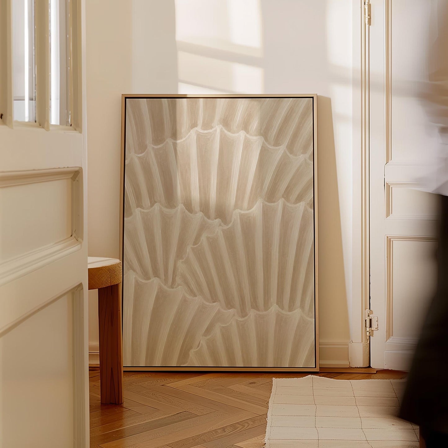 Overlapping fan shells in warm sand and taupe, canvas wall art presented in a light, minimal room