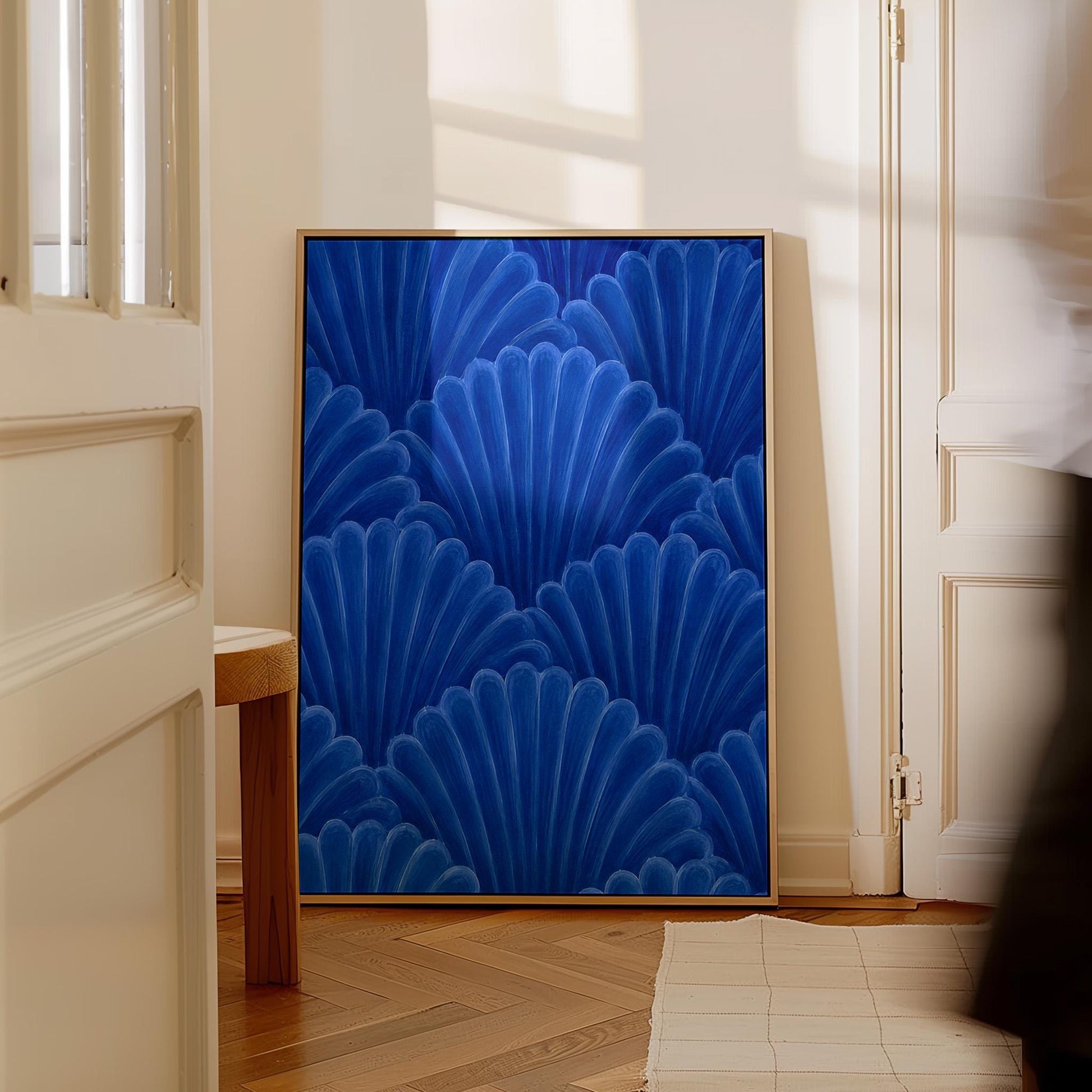 Fan shaped shell scales pattern in sapphire blue, canvas wall art hanging in a calm, modern living space