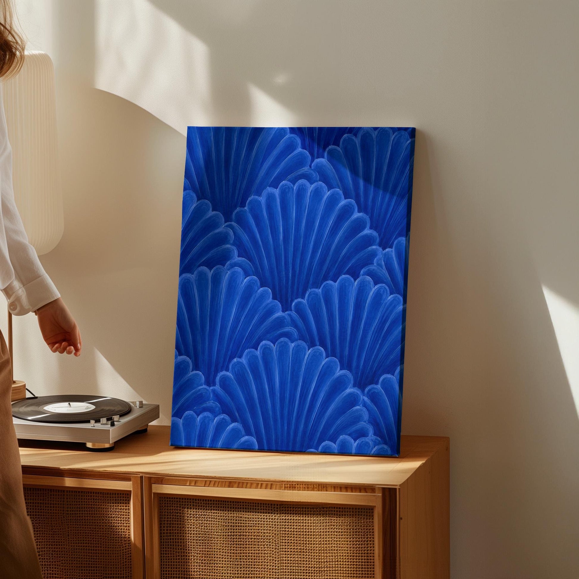 Fan shaped shell scales pattern in sapphire blue, canvas print presented in a light, minimal room