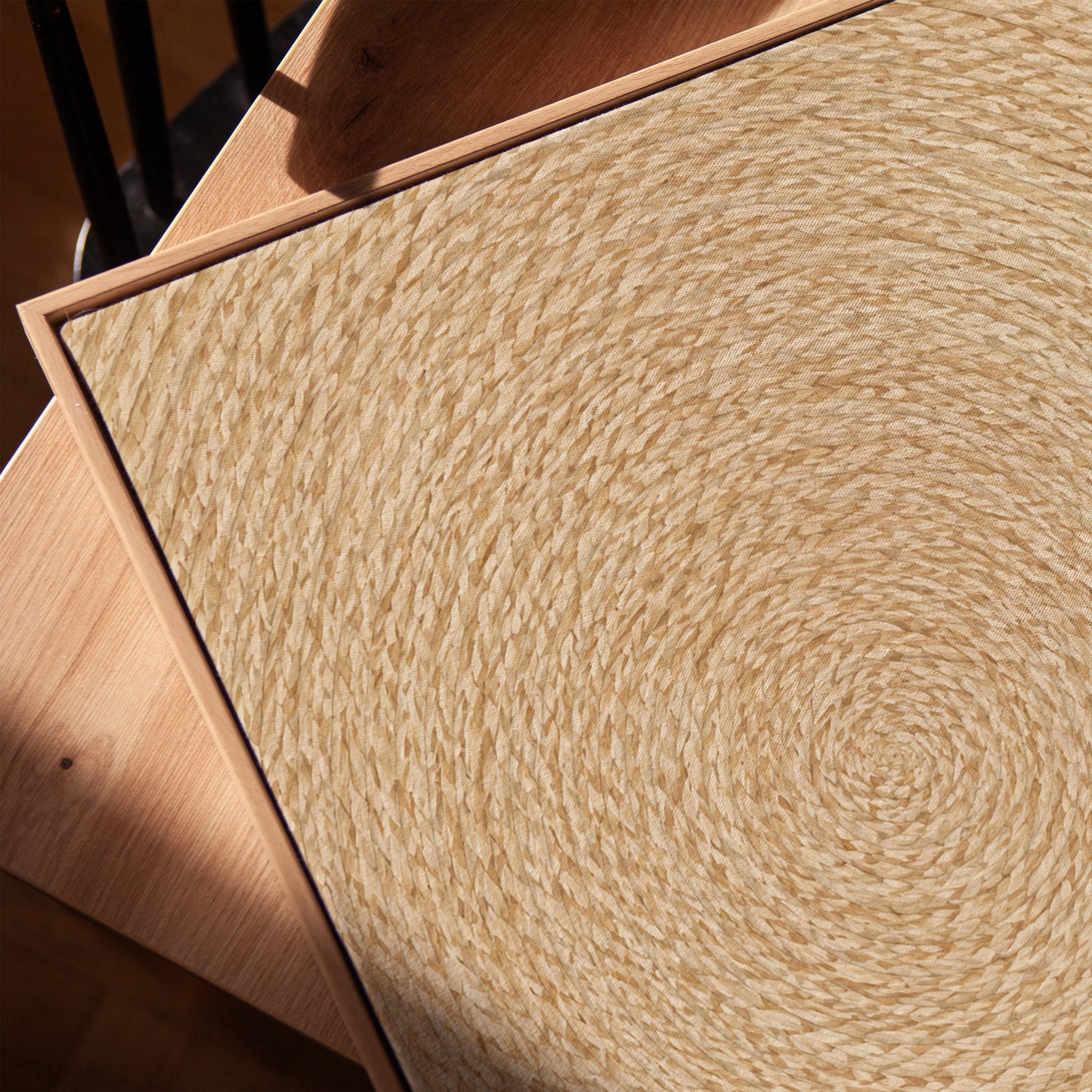 Spiral coiled circle pattern in wheat and straw gold, canvas print in a warm, minimally styled interior