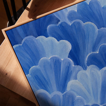 Petal fan clusters in cornflower and powder blue, canvas print in a warm, minimally styled interior
