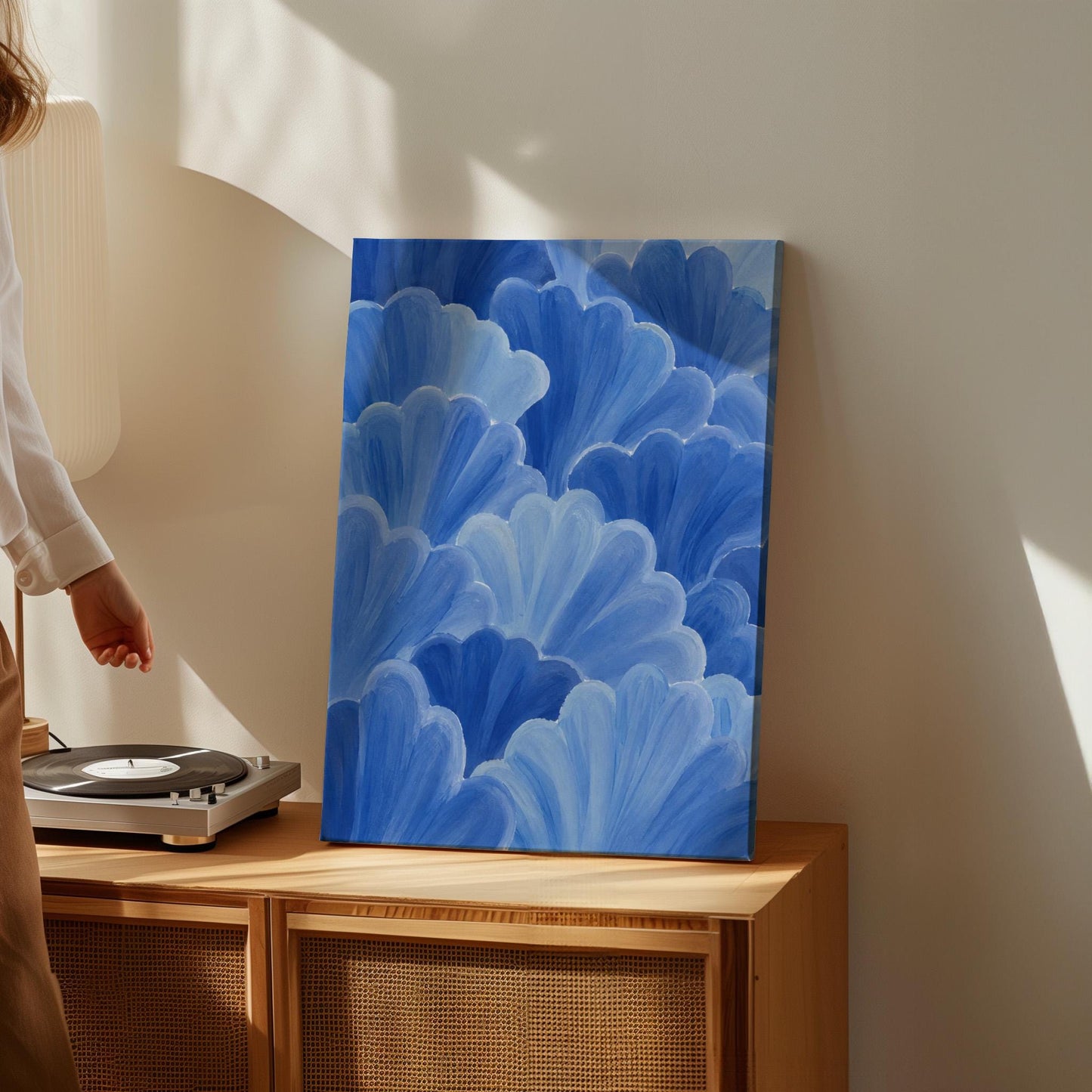 Petal fan clusters in cornflower and powder blue, canvas print seen in a warm interior with natural light