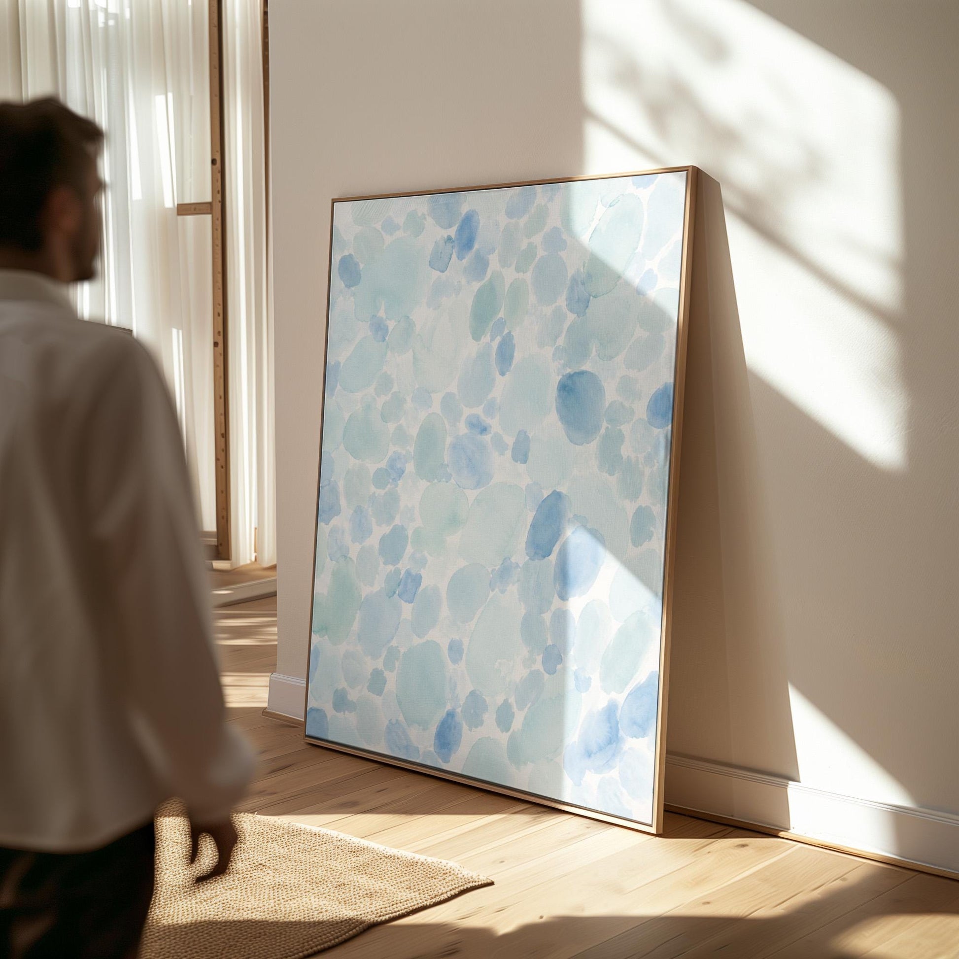 Dappled watercolor petals in light baby blue, canvas print displayed on a neutral wall in a styled interior