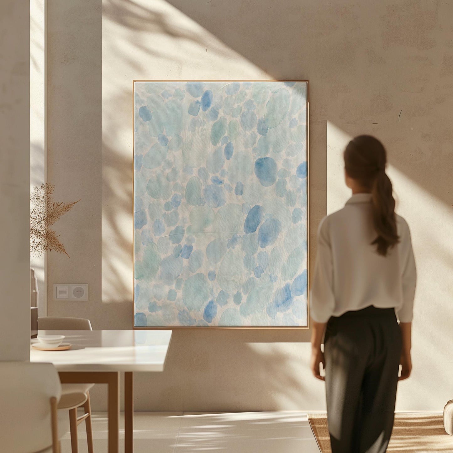 Dappled watercolor petals in light baby blue, canvas print shown in a sunlit, contemporary room
