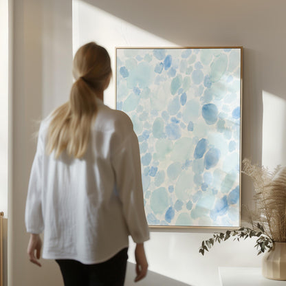 Dappled watercolor petals in light baby blue, canvas print hanging in a calm, modern living space