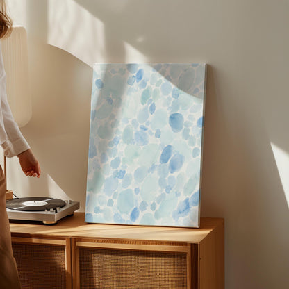 Dappled watercolor petals in light baby blue, canvas wall art seen in a warm interior with natural light