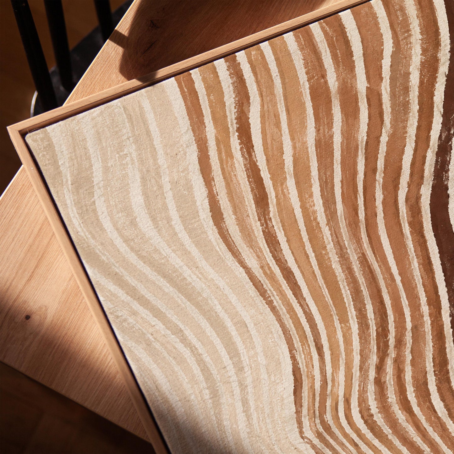 Rippling contour lines in cocoa brown and cream, canvas print in a warm, minimally styled interior