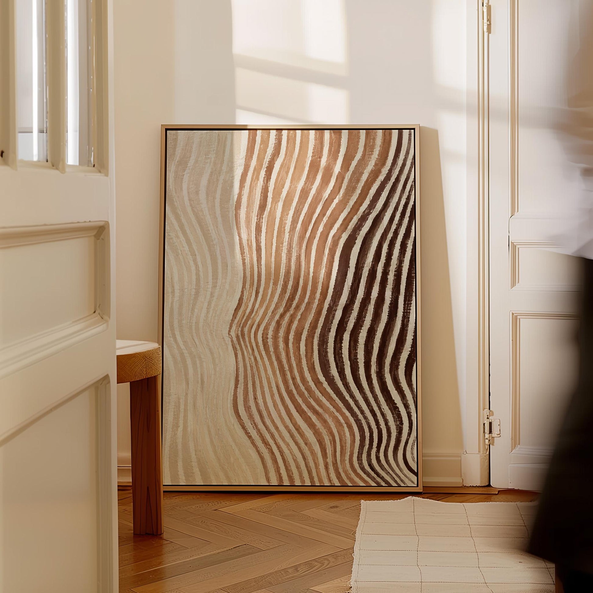 Rippling contour lines in cocoa brown and cream, canvas wall art presented in a light, minimal room