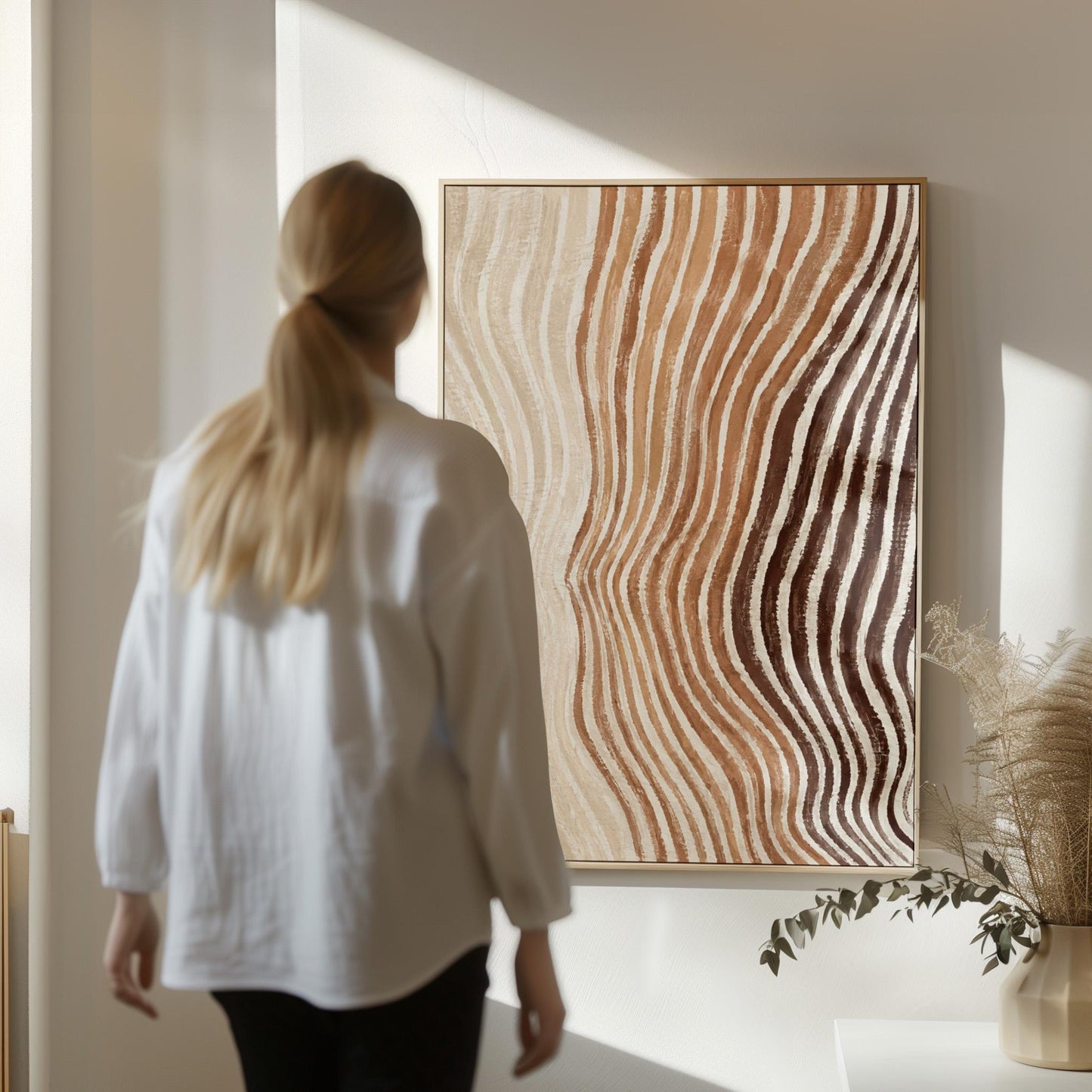 Rippling contour lines in cocoa brown and cream, canvas wall art on a quiet wall in a considered interior
