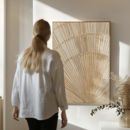Golden fan palm leaf with radiating rays on cream, canvas print hanging in a calm, modern living space