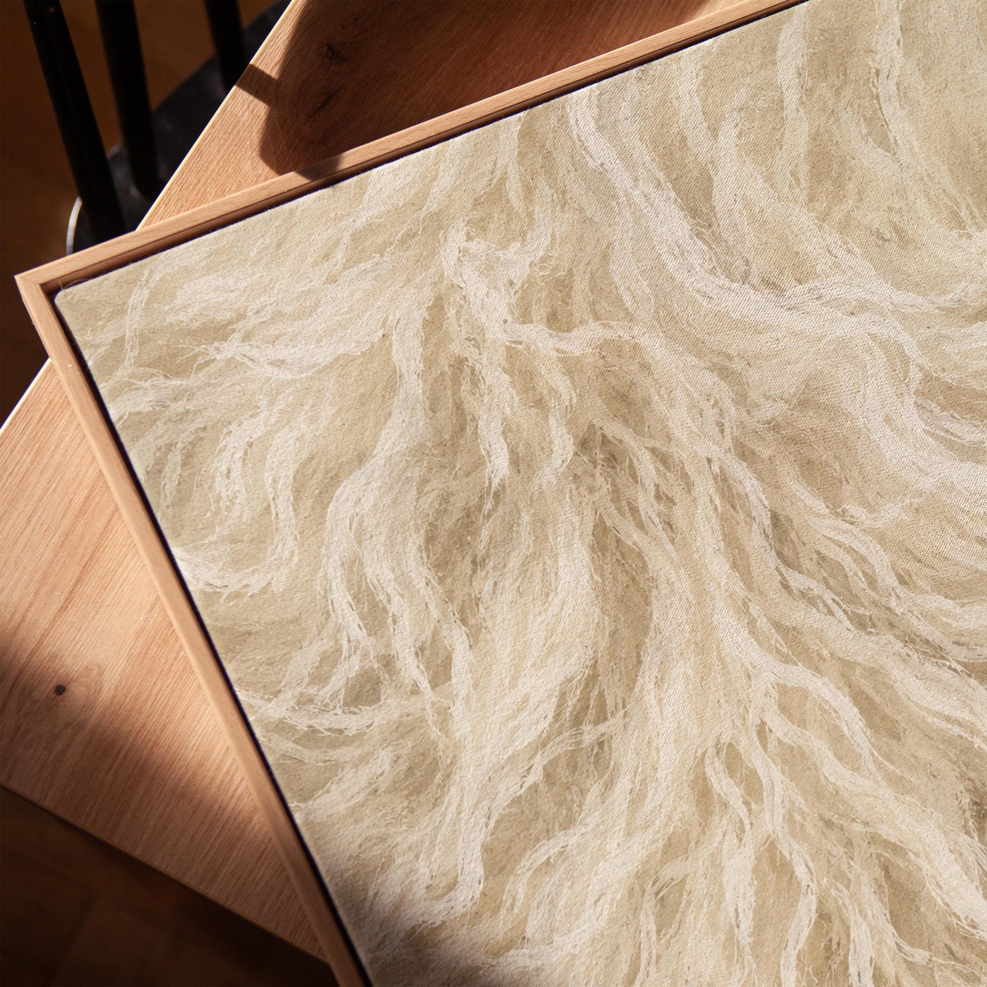 Soft flowing cream strands filling the frame, canvas print in a warm, minimally styled interior