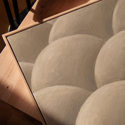 Rows of shaded dome shapes in deep taupe, canvas print in a warm, minimally styled interior
