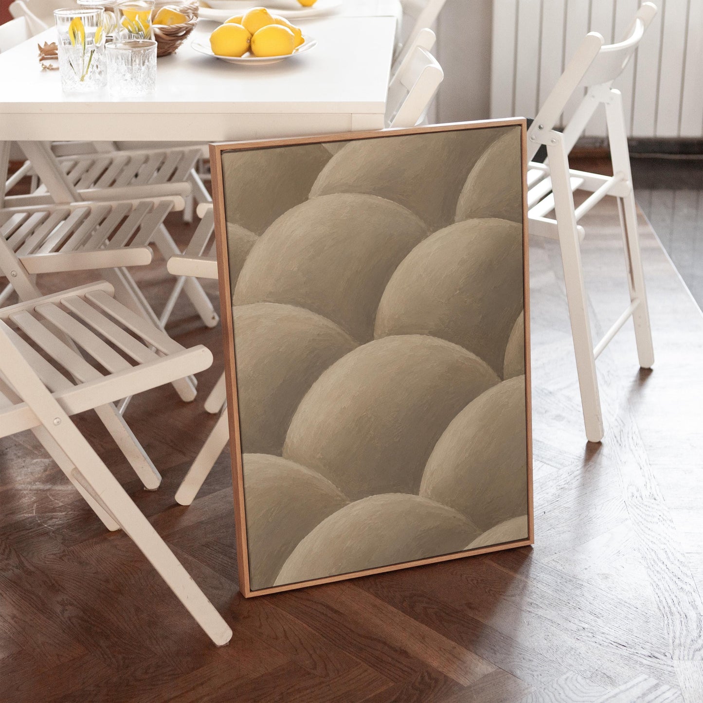 Rows of shaded dome shapes in deep taupe, canvas wall art hanging in a calm, modern living space
