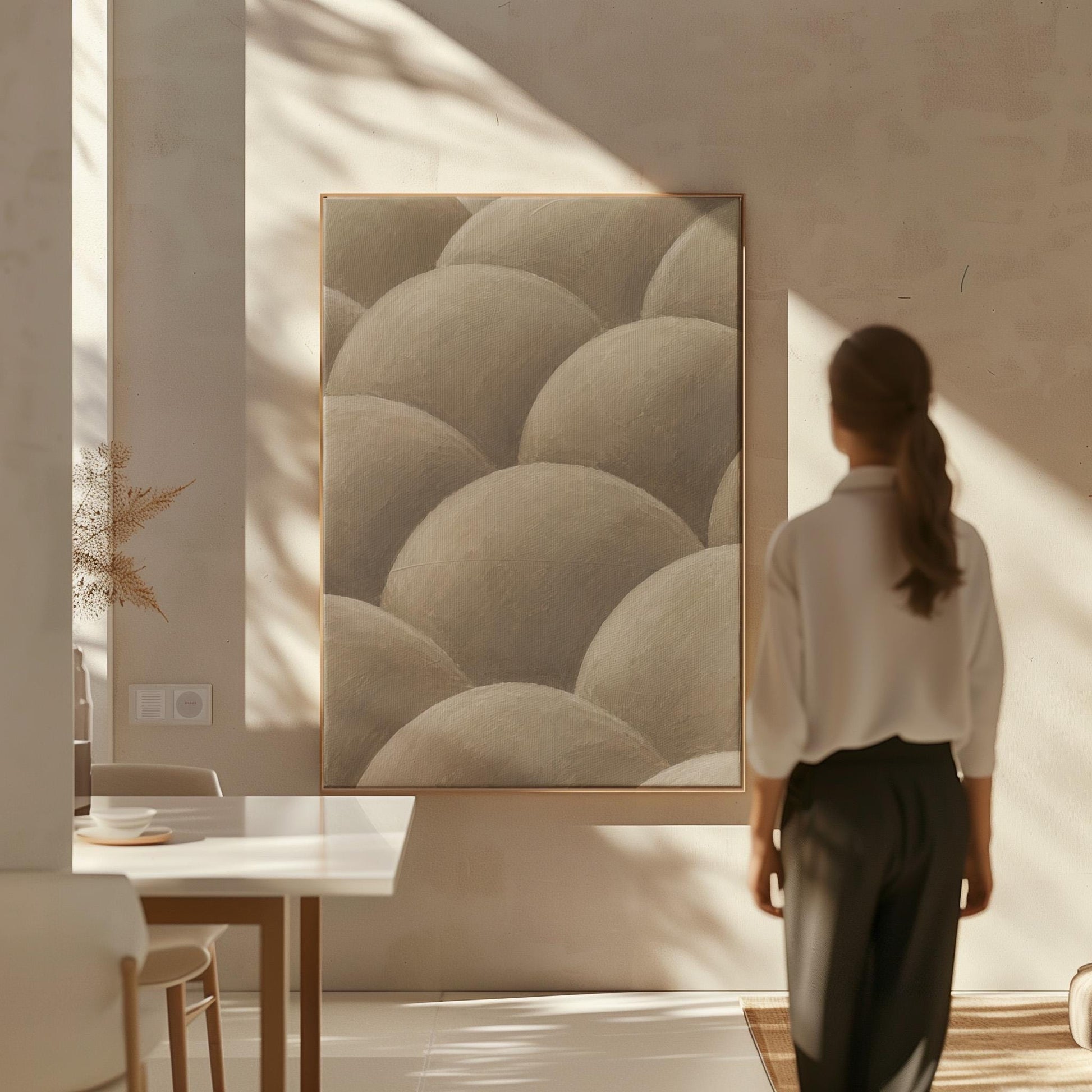 Rows of shaded dome shapes in deep taupe, canvas print seen in a warm interior with natural light