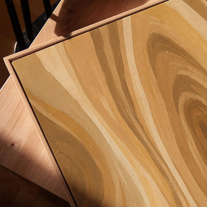 Concentric swirling lines in amber and caramel, canvas print in a warm, minimally styled interior