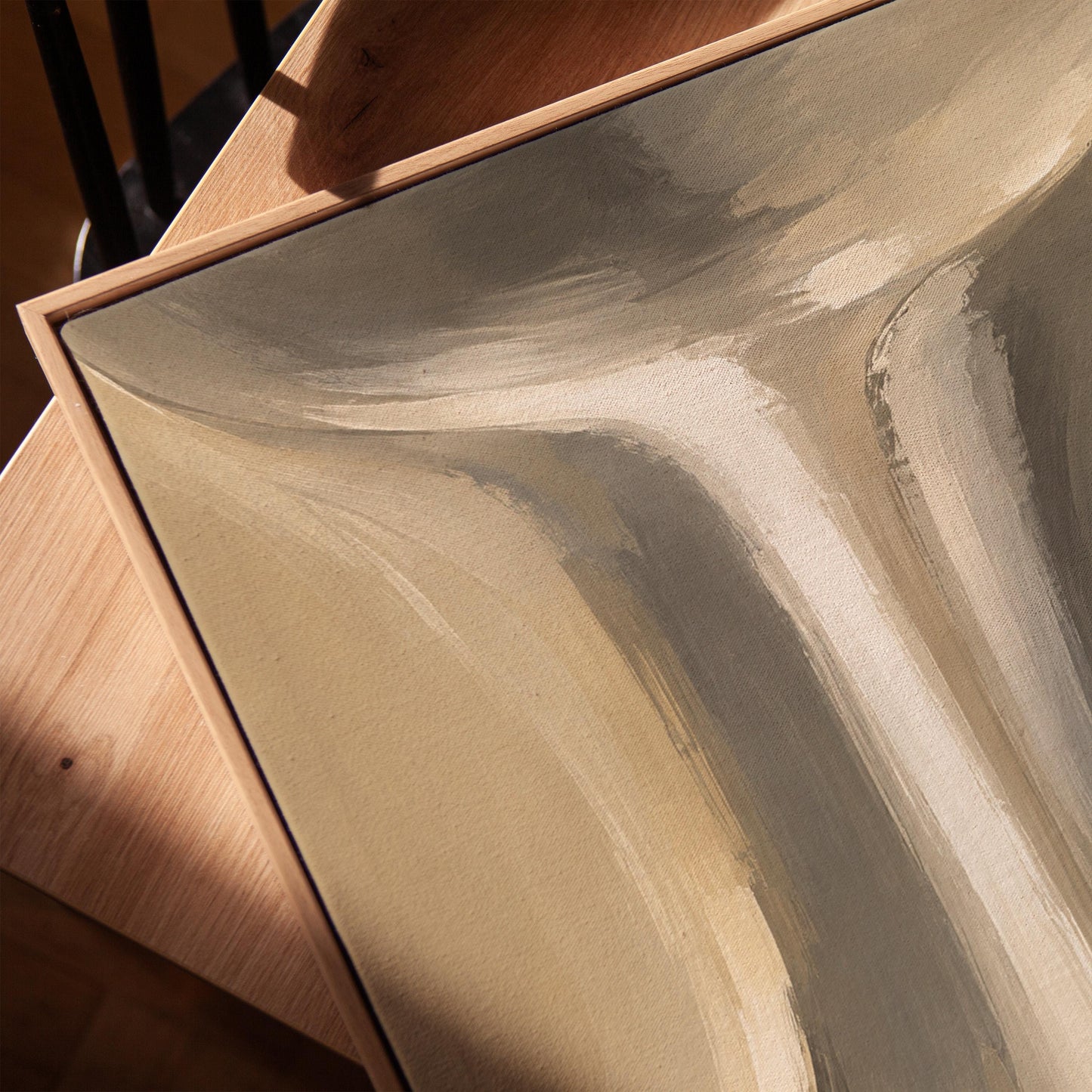 Elegant hourglass curve form in gray and taupe, canvas print in a warm, minimally styled interior