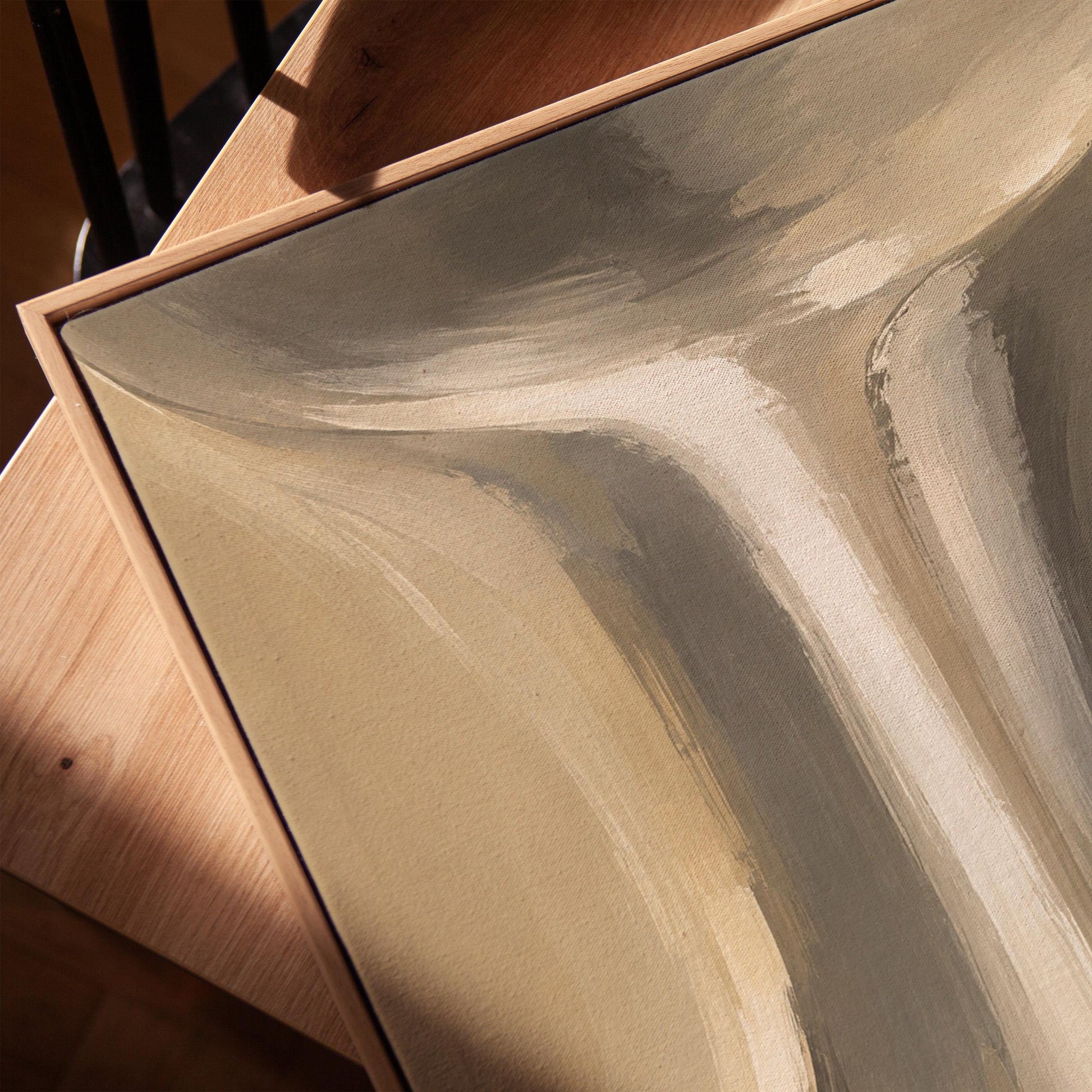Elegant hourglass curve form in gray and taupe, canvas print in a warm, minimally styled interior