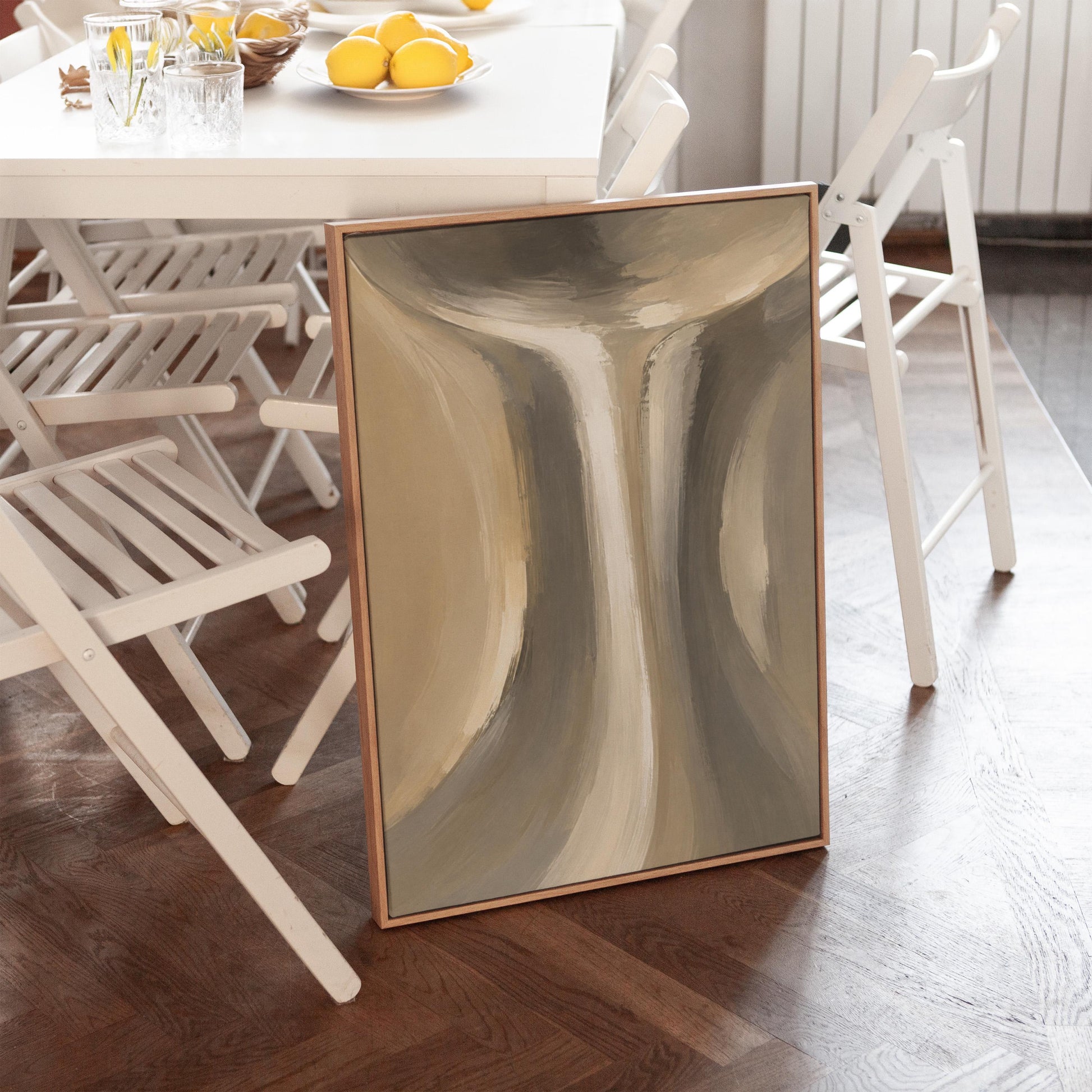 Elegant hourglass curve form in gray and taupe, canvas print shown in a sunlit, contemporary room