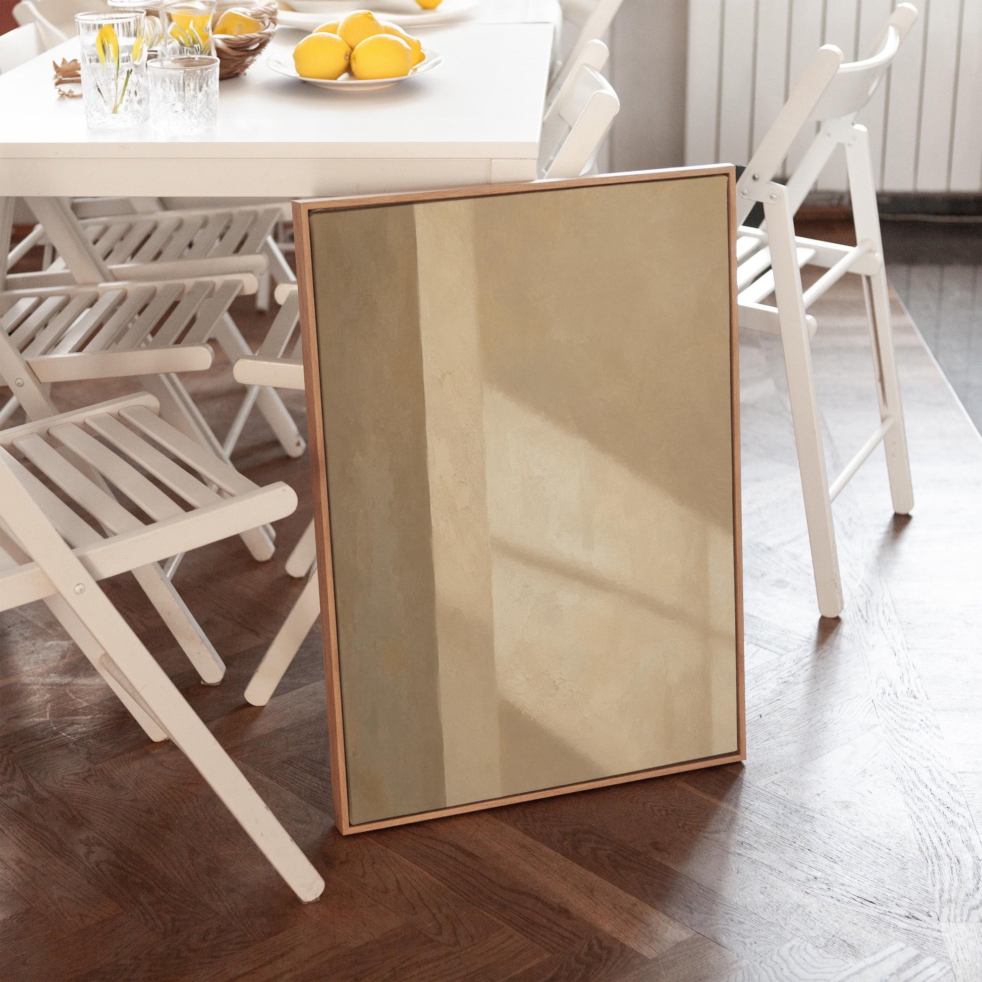 Vertical bands of light and shadow on warm beige, canvas print seen in a warm interior with natural light