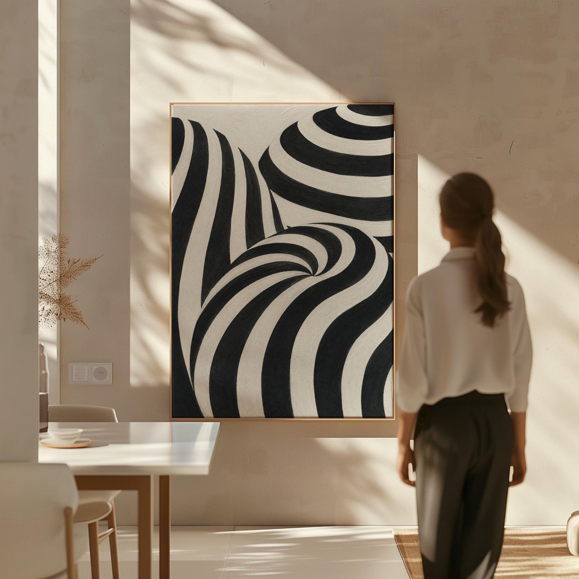Swirling black and white striped forms, canvas wall art hanging in a calm, modern living space