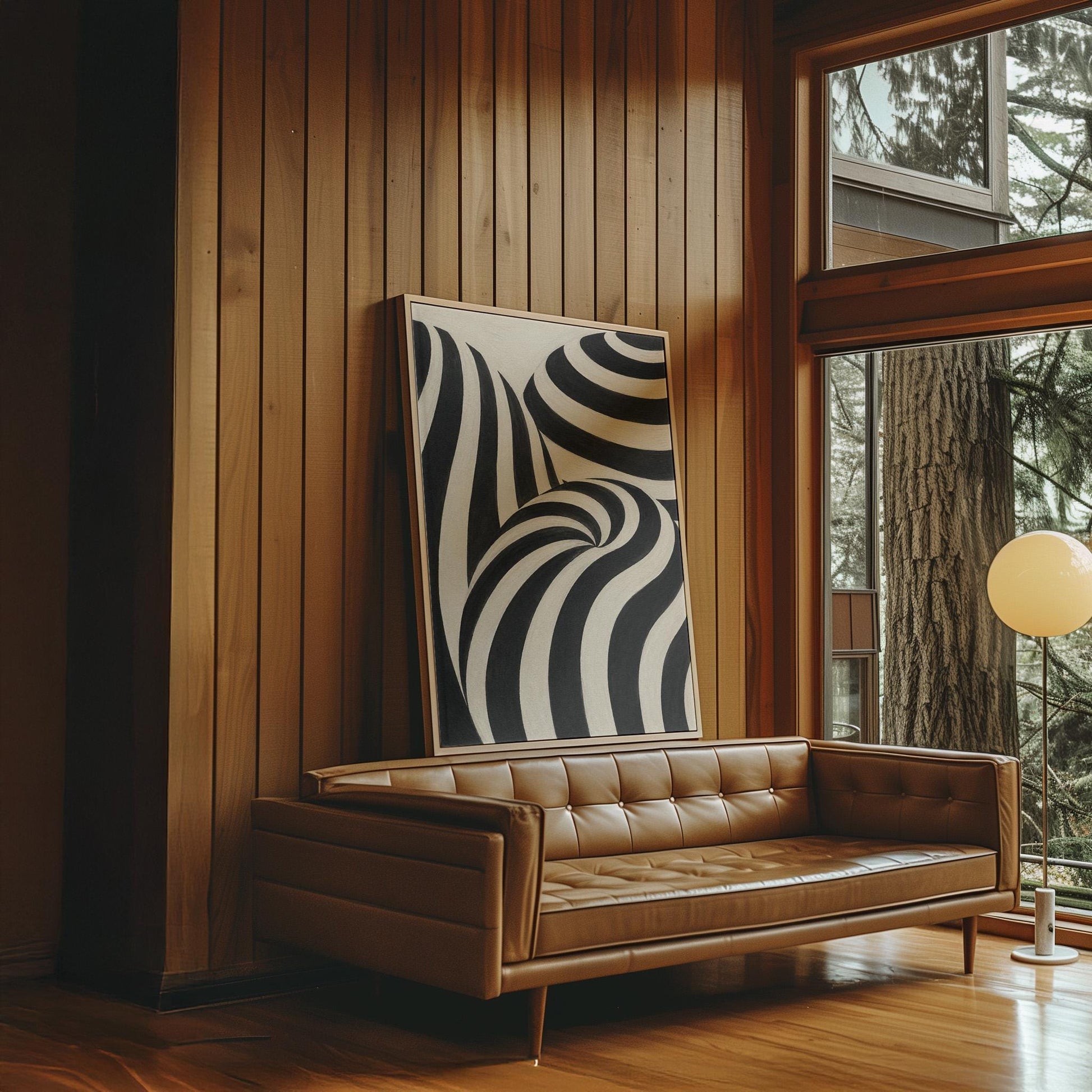 Swirling black and white striped forms, canvas wall art on a quiet wall in a considered interior