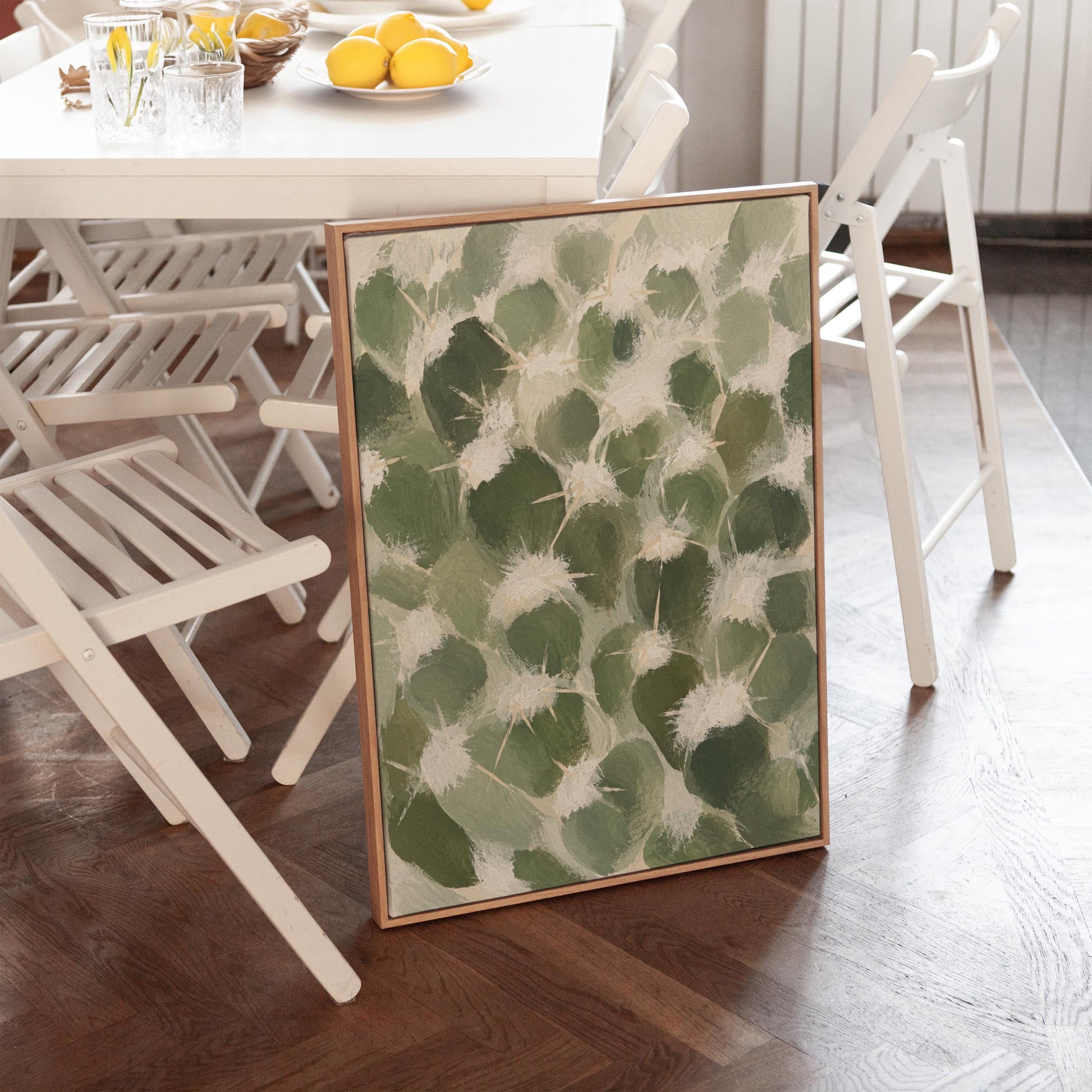 Cactus pads pattern with pale spines in sage green, canvas print seen in a warm interior with natural light