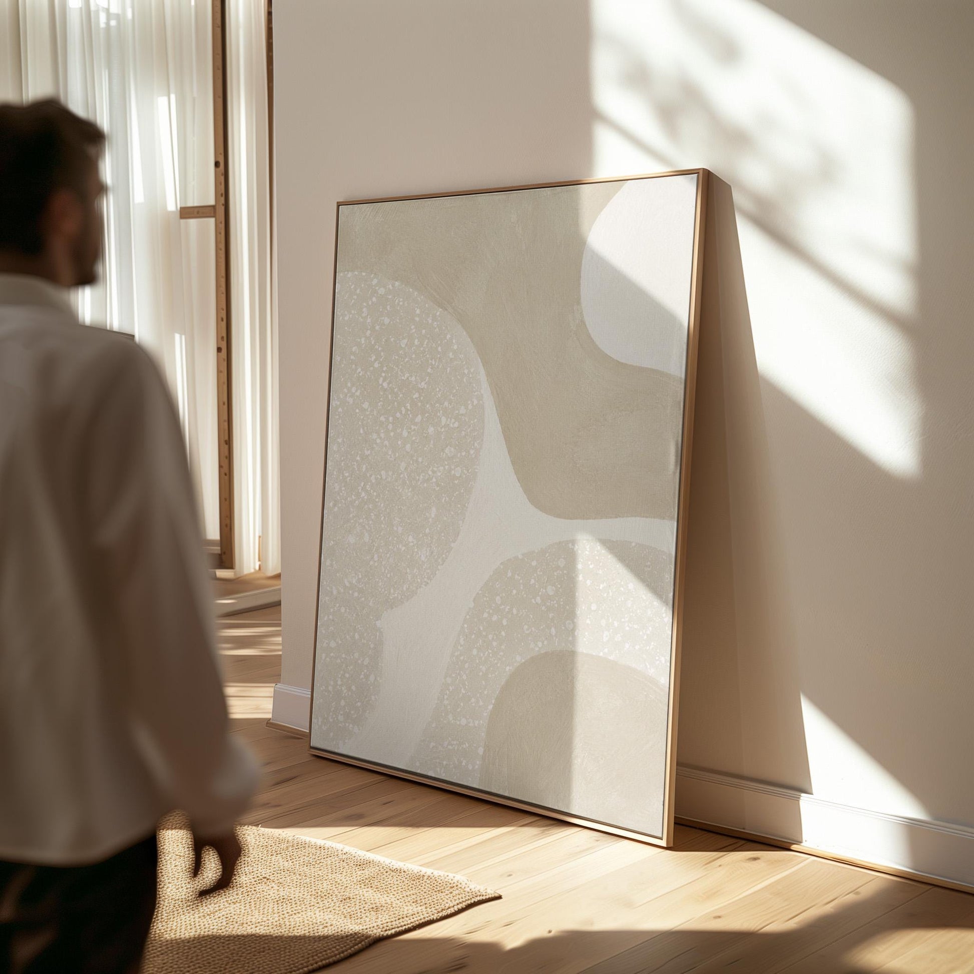 Soft speckled organic shapes in pearl and cream, canvas print presented in a light, minimal room