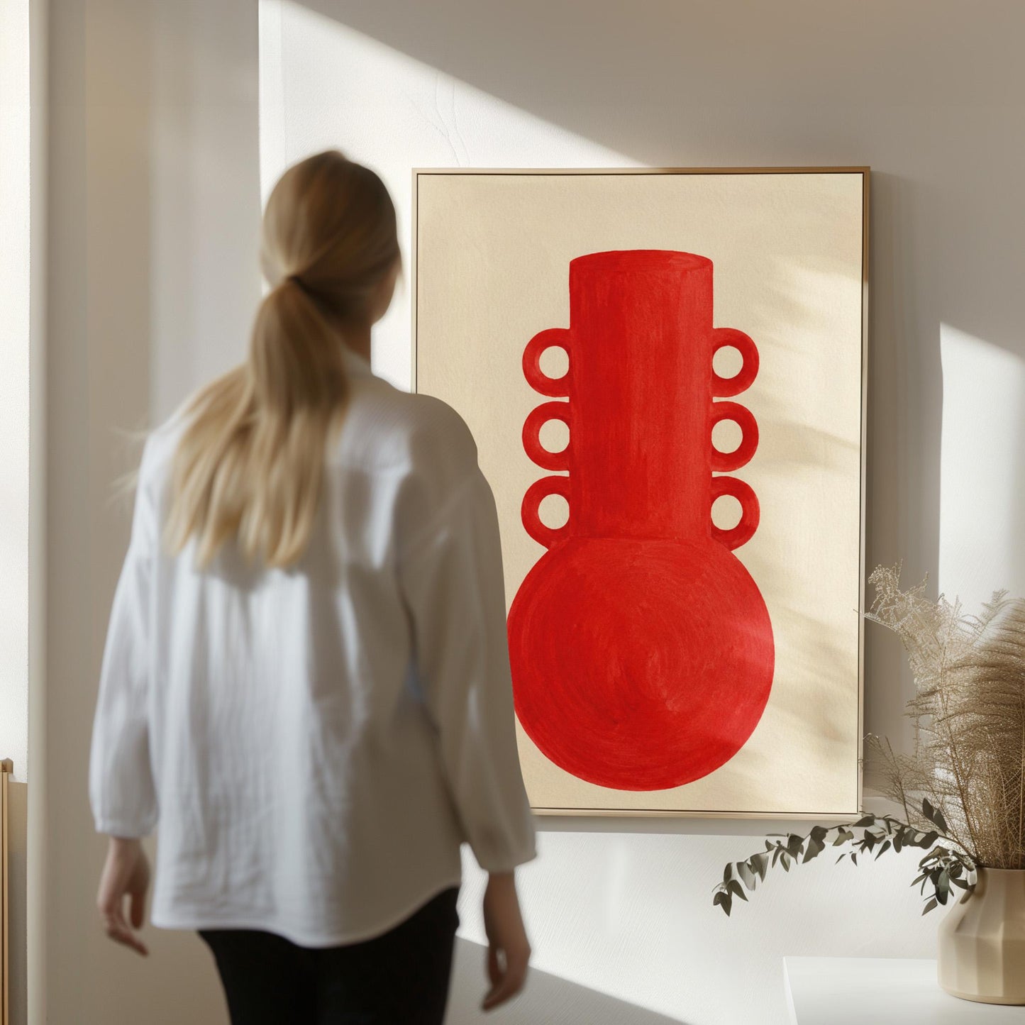 Bold red vessel with ring handles on cream background, canvas wall art styled against a soft white wall