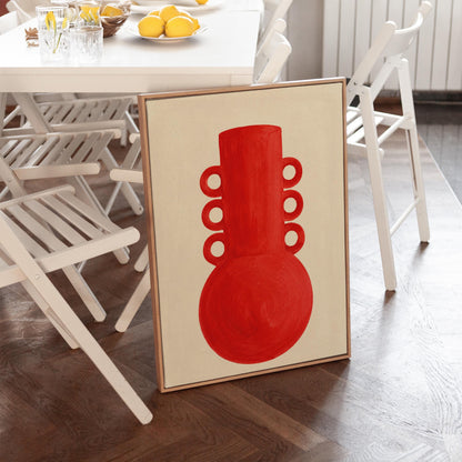 Bold red vessel with ring handles on cream background, canvas wall art presented in a light, minimal room