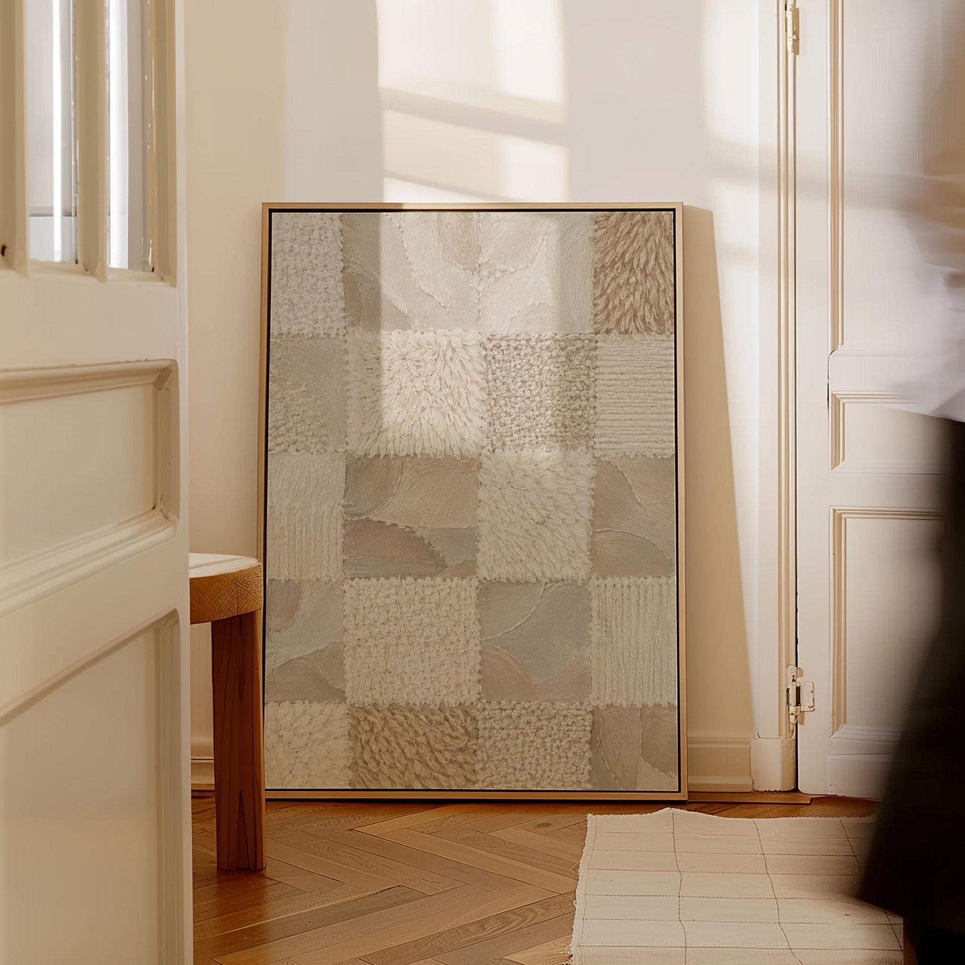 Checkered patchwork of soft cream and beige squares, canvas wall art hanging in a calm, modern living space