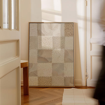 Checkered patchwork of soft cream and beige squares, canvas wall art hanging in a calm, modern living space